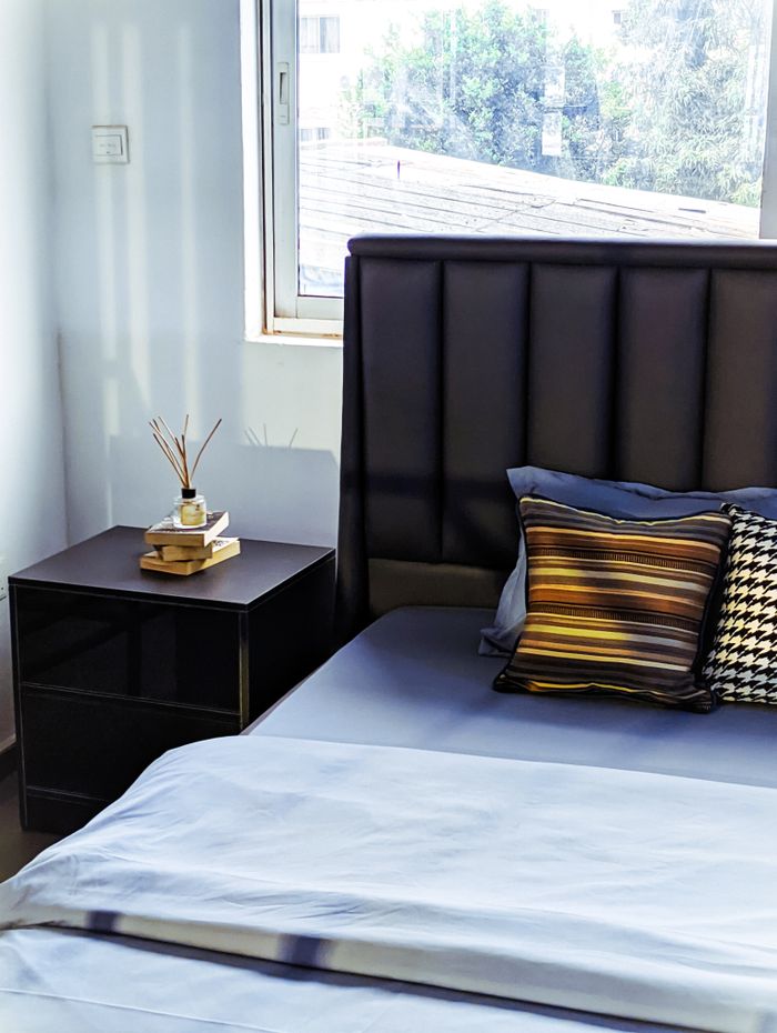 Mastering the First Impression: Your intriguing post title goes here Elegant bedroom interior featuring a designer bed and stylish furniture with natural light.