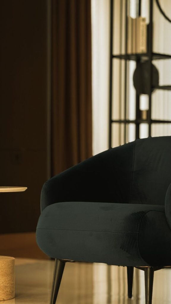 Sophisticated indoor setting featuring a dark velvet armchair and modern decor.